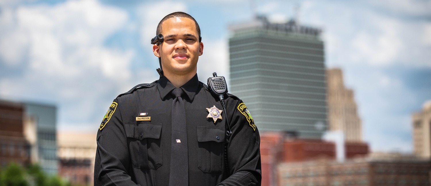 Deputy standing with the Winston-Salem, NC skyline in the background