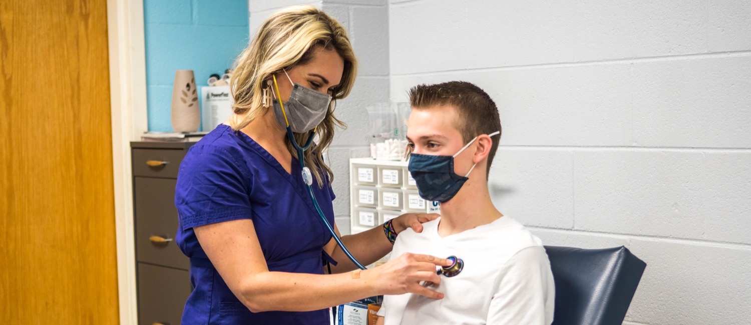 Campus nurse working with student