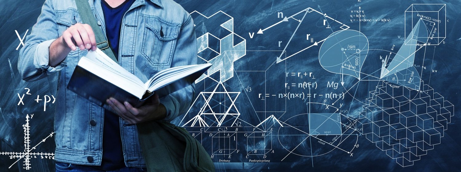 Student holding book in front of mathematics chalkboard