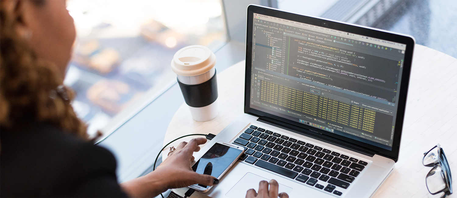 Woman programming on laptop